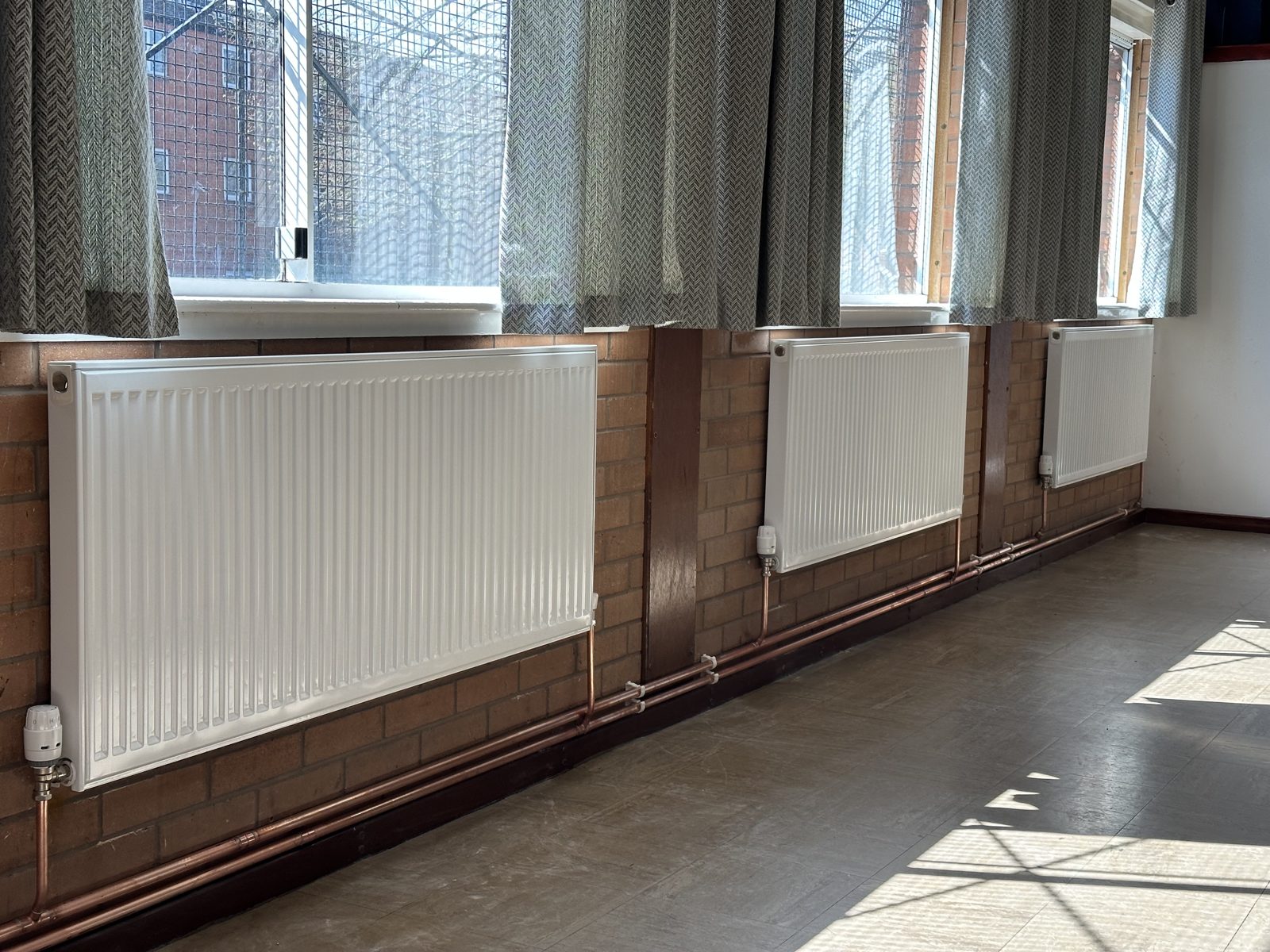 Row of new radiators installed in a large room
