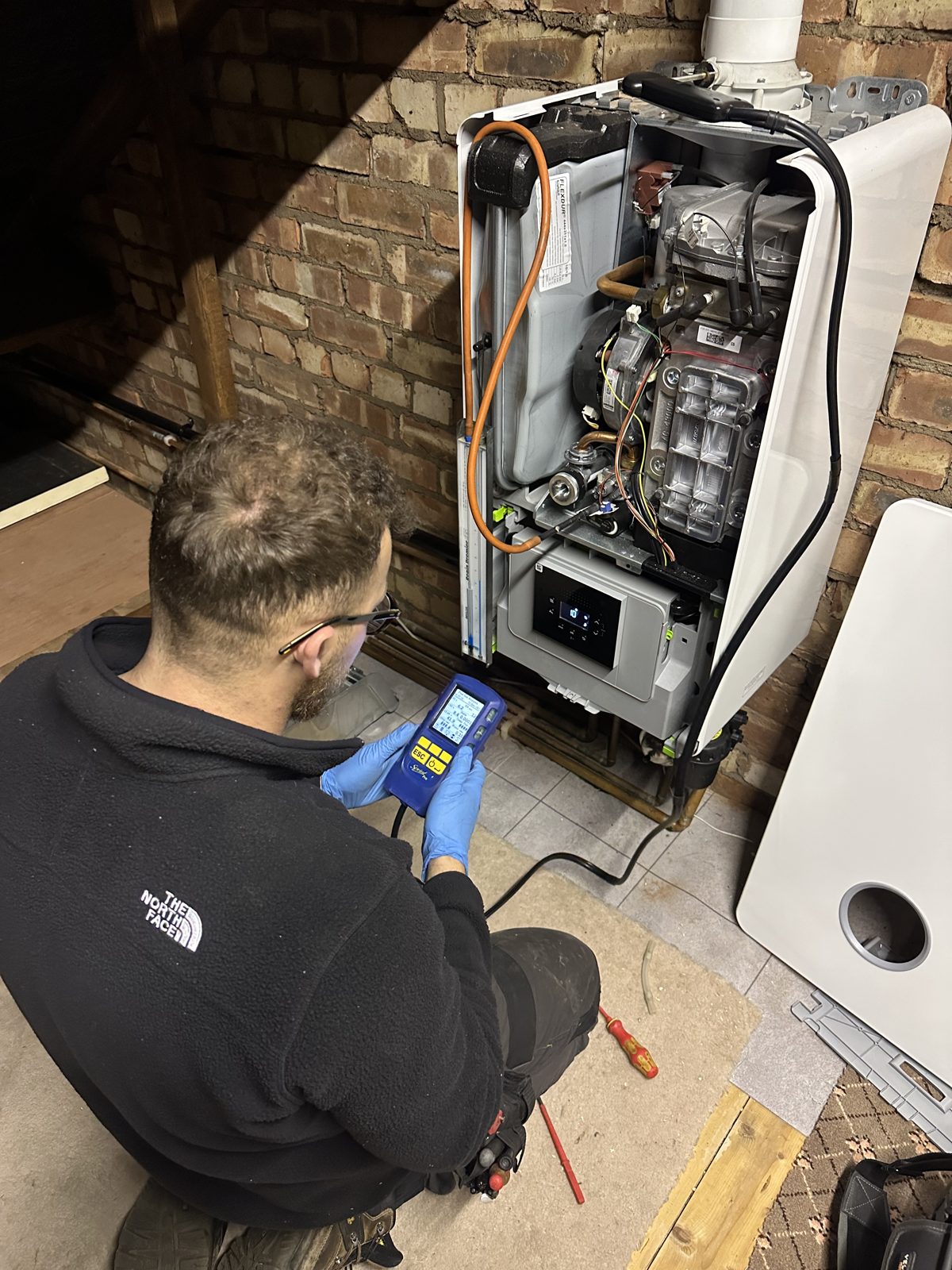 Luc Redmond testing a boiler with a flue gas analyser