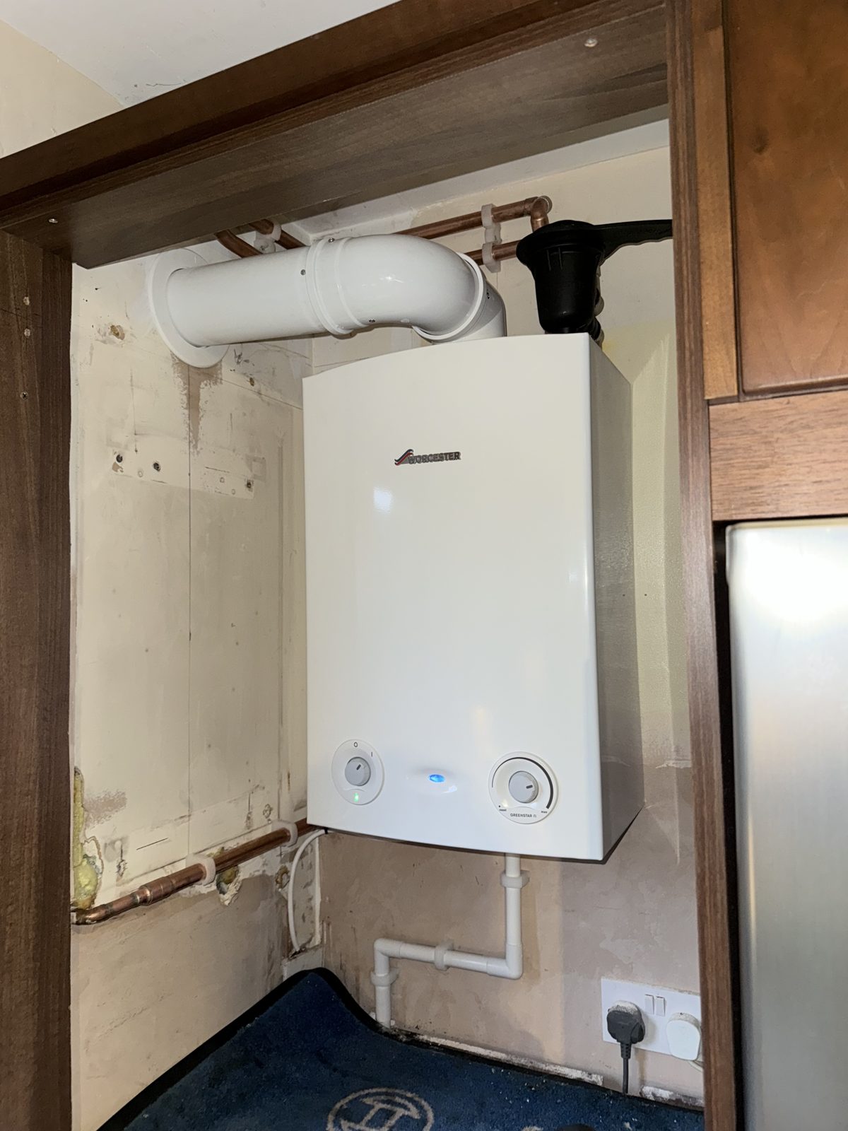 Combi boiler fitted inside a kitchen cupboard